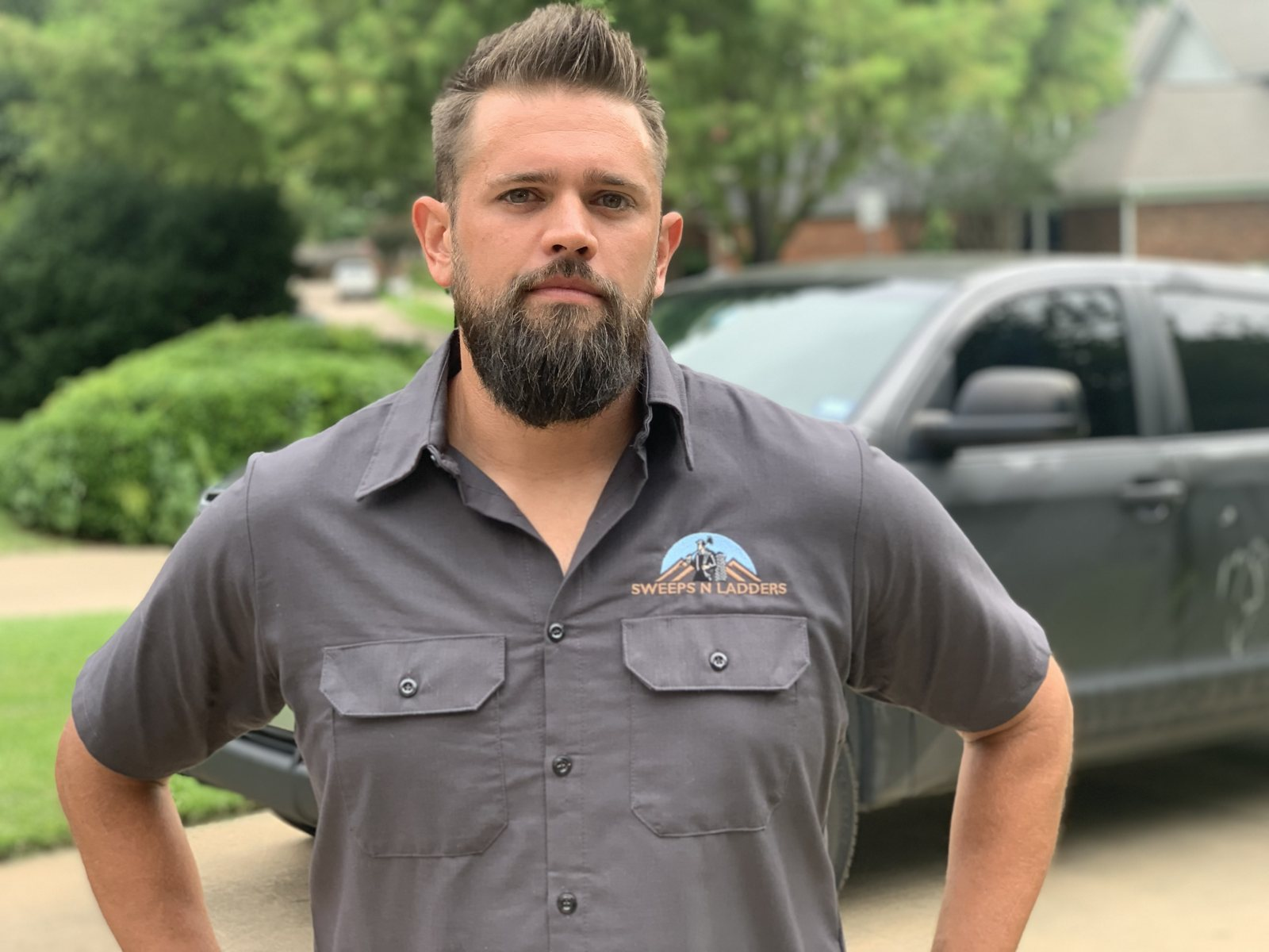 Paul Herman, owner of Sweeps N Ladders, in front of the company truck