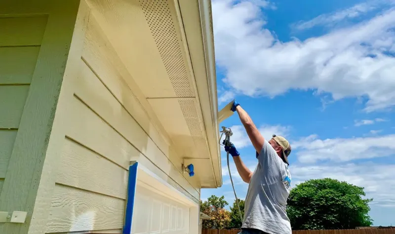 Technician working on exterior siding